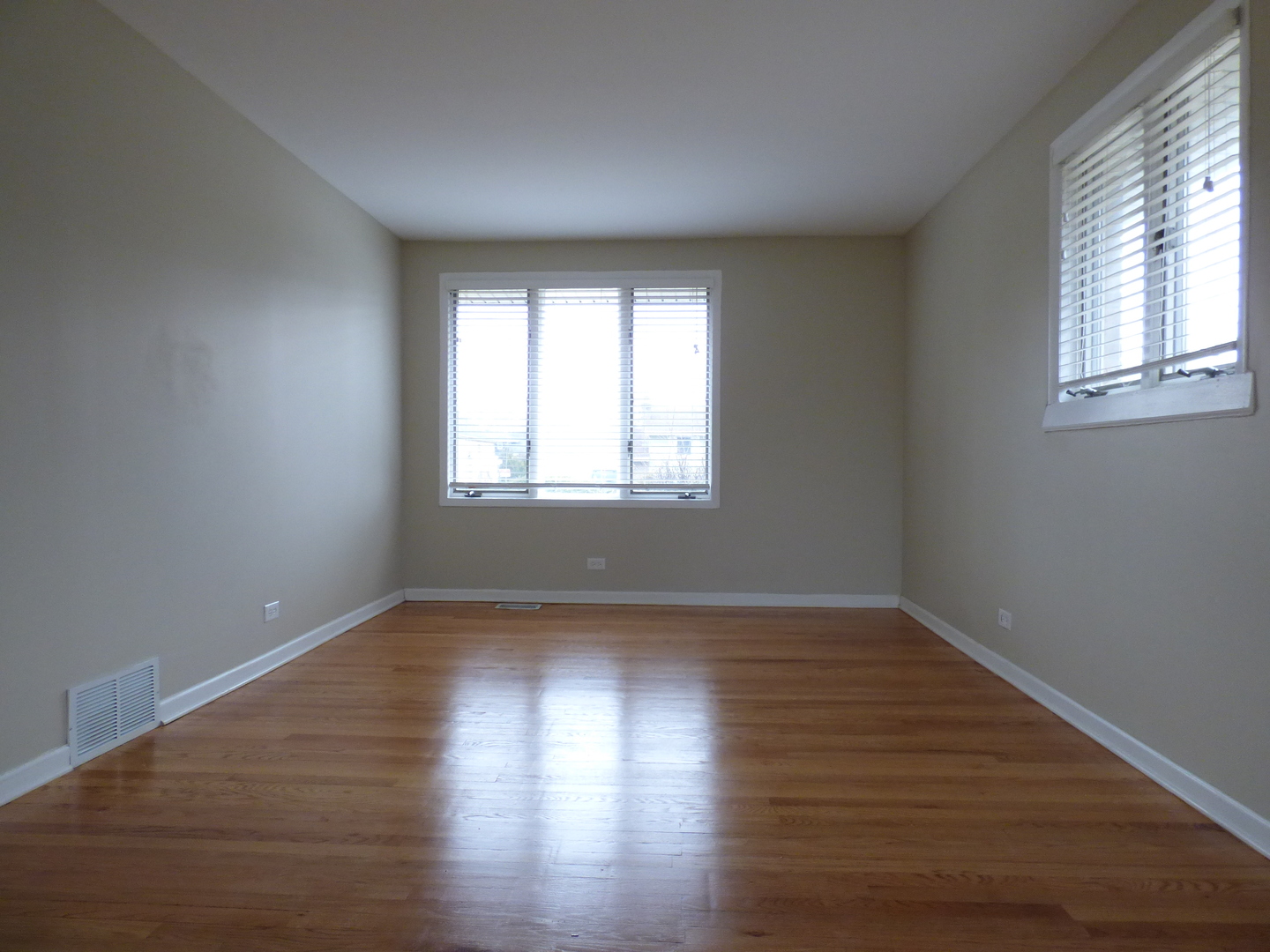 4N261 7th Avenue Addison, IL 60101 - Photo 7 of 31 a view of an empty room with wooden floor and a window