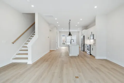 a view of kitchen with wooden floor and electronic appliances