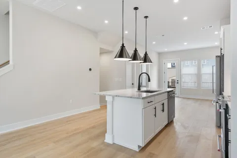 a view of a kitchen with a sink and cabinets