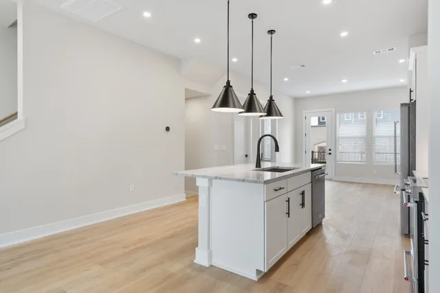 a view of a kitchen with a sink and cabinets