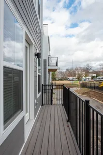 a view of a balcony with wooden fence