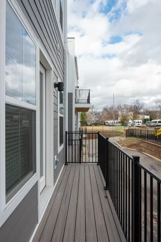a view of a balcony with wooden fence