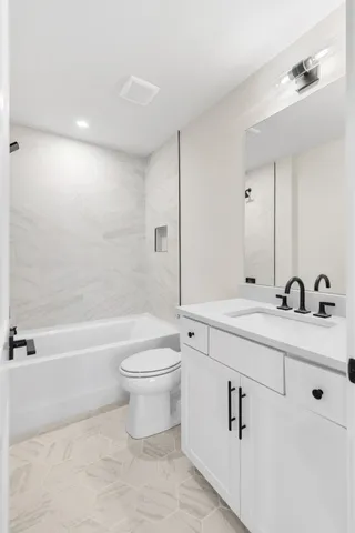 a bathroom with a double vanity sink toilet and shower