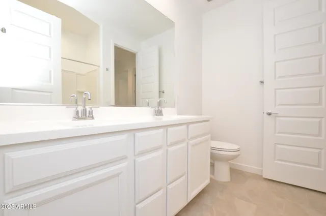 a bathroom with a toilet a sink and a mirror