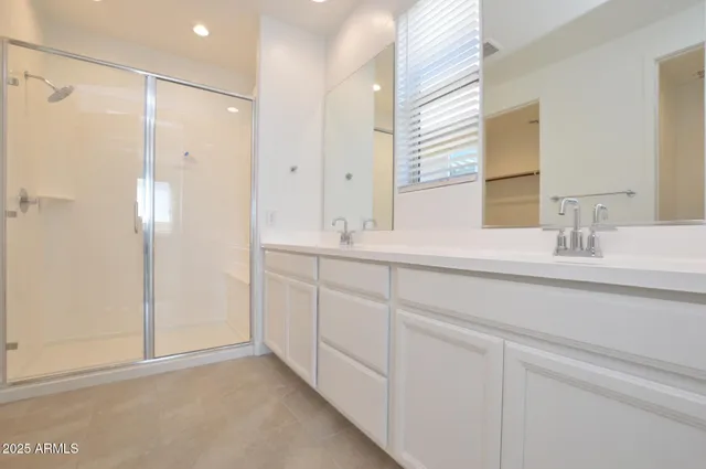 a bathroom with a double vanity sink mirror and
