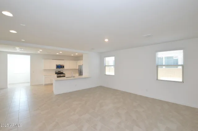 an empty room with windows and pillars in it