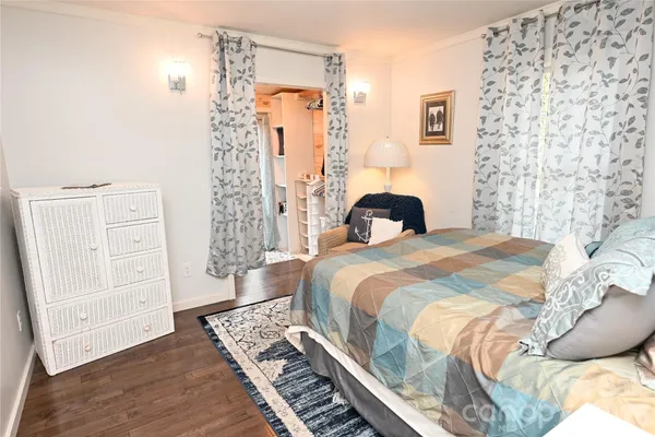 a bedroom with a bed and a rug