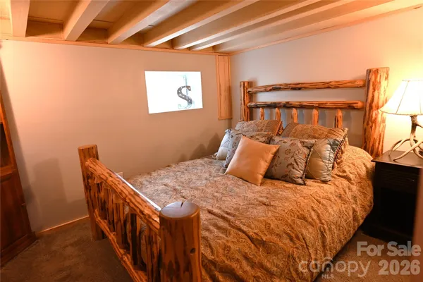 a bedroom with furniture and a lamp