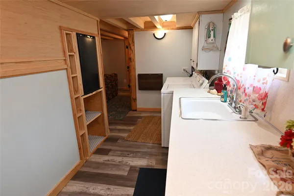 a kitchen with a sink appliances and cabinets