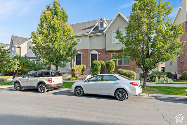 2092 Cres Drive South Mapleton, UT 84664 - Photo 22 of 26 Two-story townhome with brick and stucco exterior, prominent gabled dormer, and mature landscaping