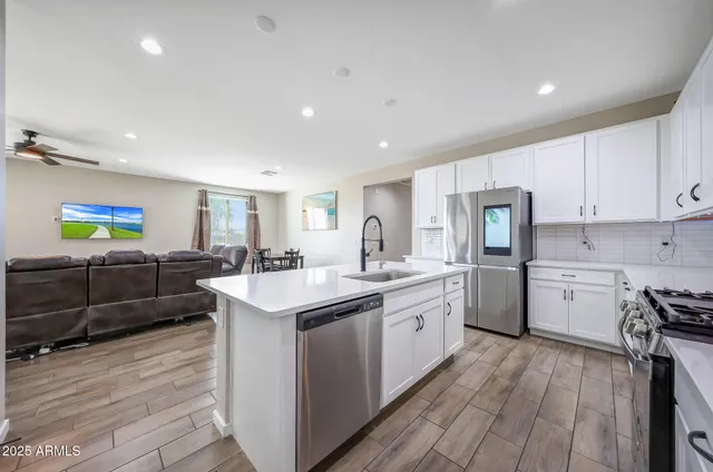 a kitchen with sink cabinets and wooden floor