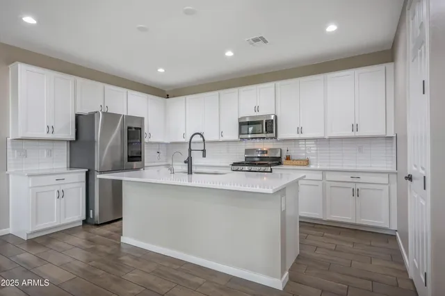 a kitchen with appliances cabinets and a sink
