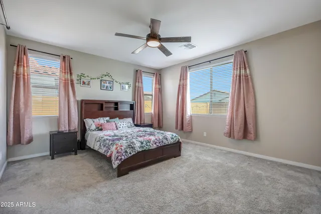 a bedroom with a large bed and a window