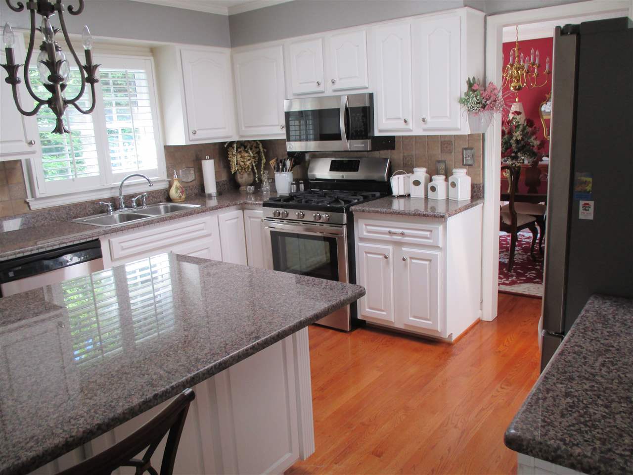 1220 Pinehurst Road Staunton, VA 24401 - Photo 6 of 24 a kitchen with granite countertop stainless steel appliances a sink a stove a refrigerator cabinets and a window