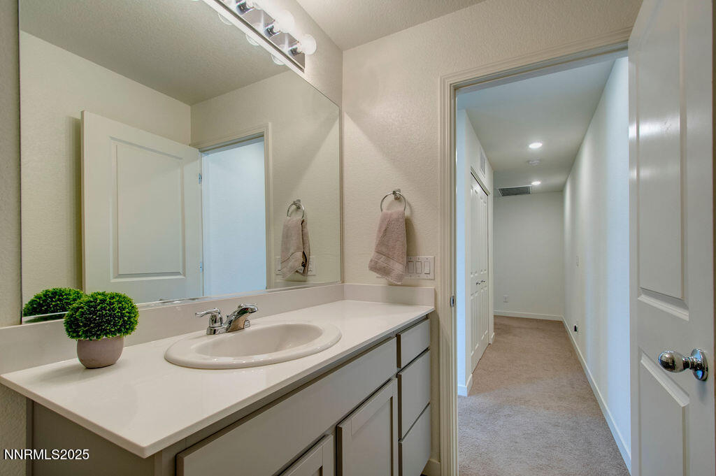 604 Selene Moon Street Reno, NV 89506 - Photo 11 of 40 a bathroom with a sink and a mirror