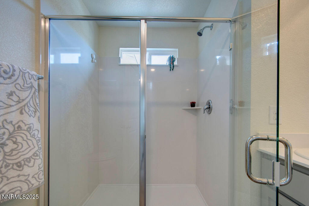 604 Selene Moon Street Reno, NV 89506 - Photo 26 of 40 a bathroom with a shower and a mirror