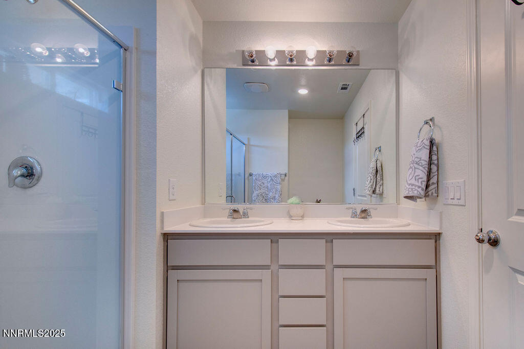 604 Selene Moon Street Reno, NV 89506 - Photo 27 of 40 a bathroom with a double vanity sink and mirror