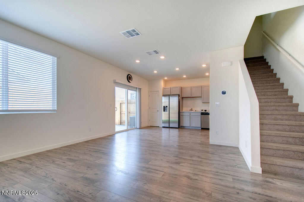 604 Selene Moon Street Reno, NV 89506 - Photo 3 of 40 an empty room with wooden floor and windows