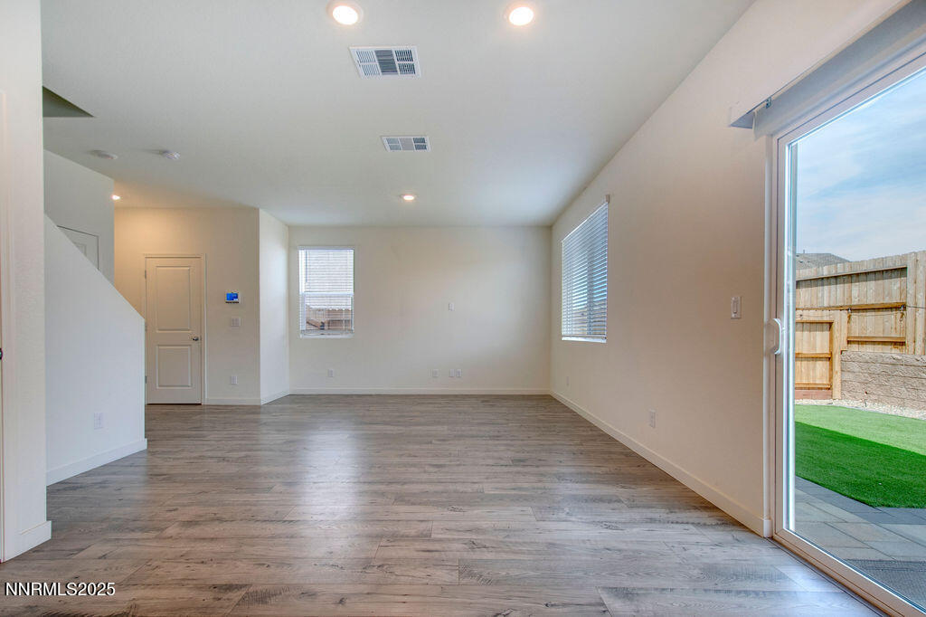 604 Selene Moon Street Reno, NV 89506 - Photo 5 of 40 an empty room with wooden floor and windows