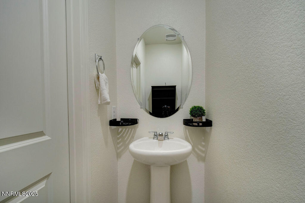 604 Selene Moon Street Reno, NV 89506 - Photo 7 of 40 a bathroom with a sink and a mirror