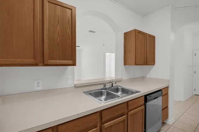 a kitchen with a sink cabinets and a wooden floor