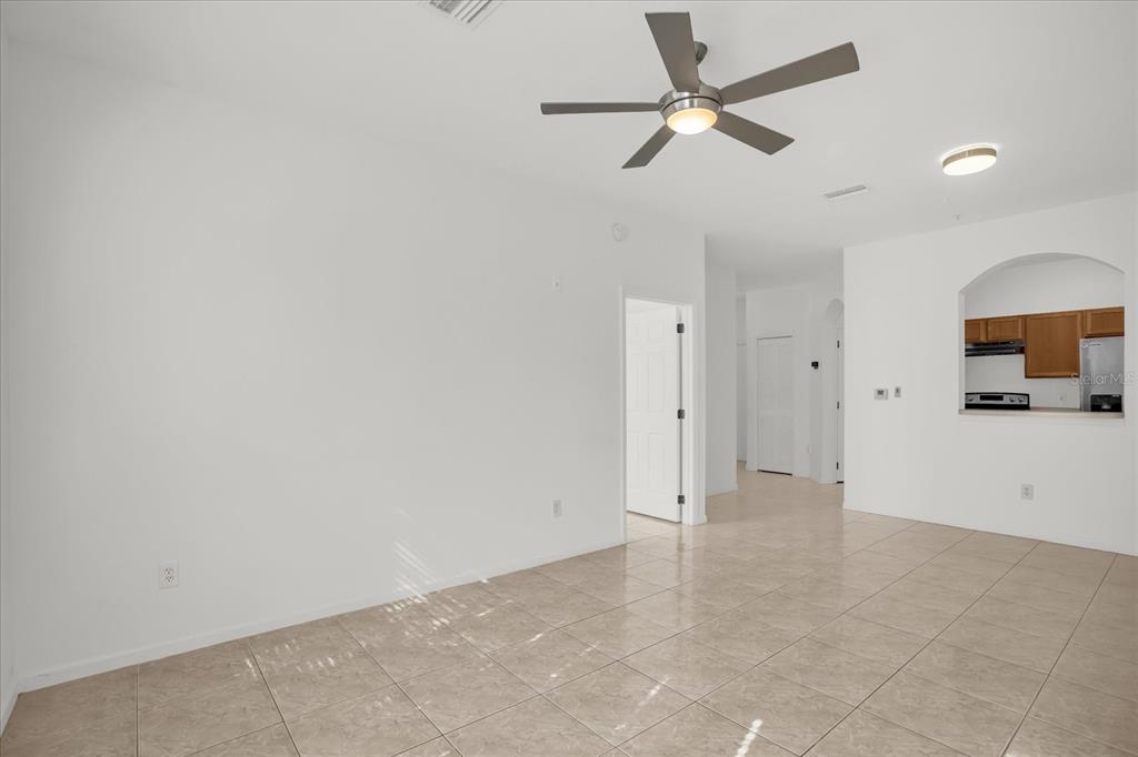 13500 Turtle Marsh Loop, Unit 811 Orlando, FL 32837 - Photo 5 of 23 an empty space with a ceiling fan and a bathroom