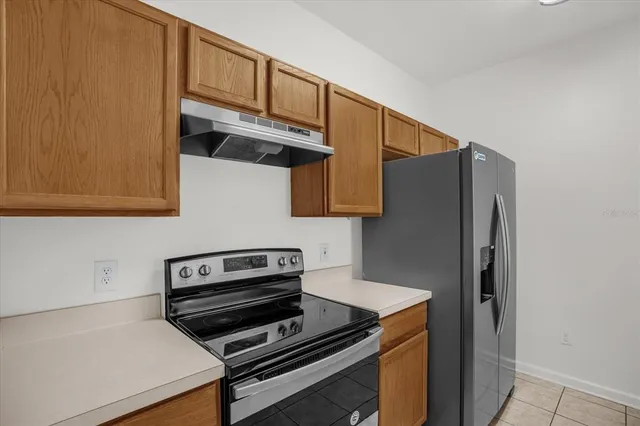a kitchen with wooden cabinets and a stove top oven