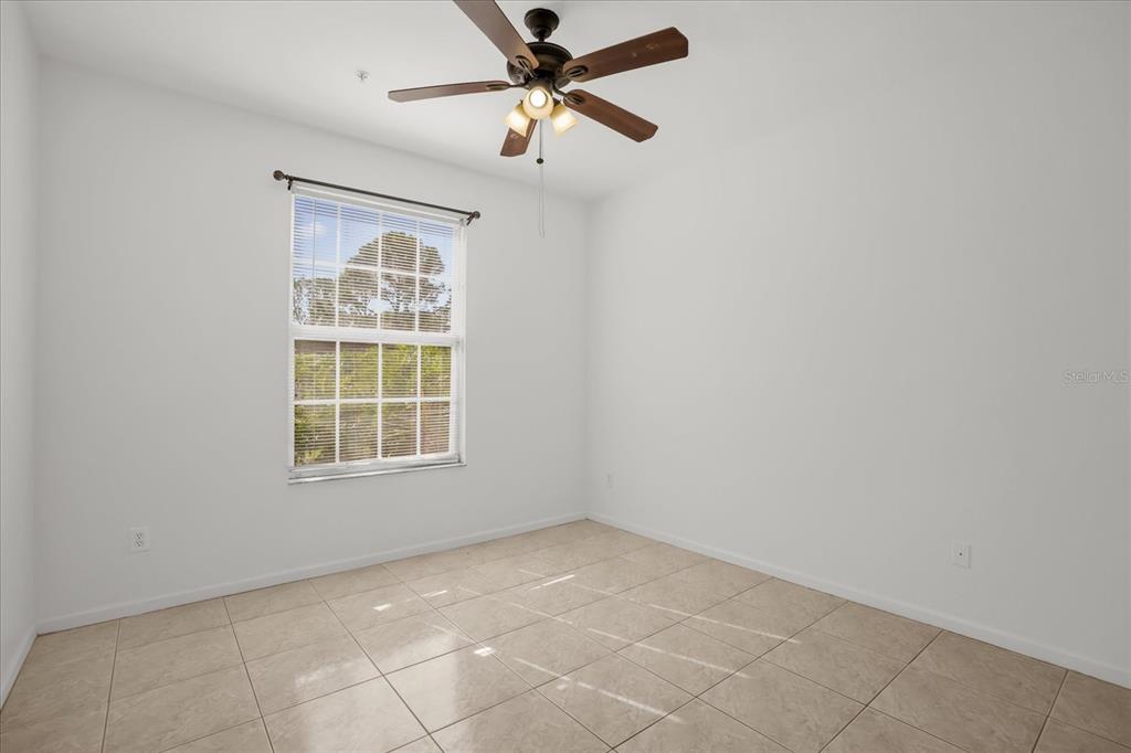 13500 Turtle Marsh Loop, Unit 811 Orlando, FL 32837 - Photo 9 of 23 an empty room with windows and fan
