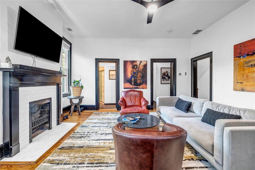 800 Myrtle Street Northeast Atlanta, GA 30308 - Photo 12 of 28 a living room with furniture a flat screen tv and a fireplace