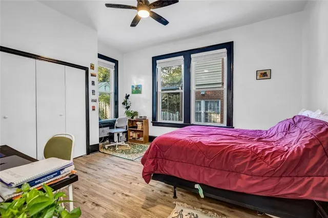a bedroom with a bed window and table