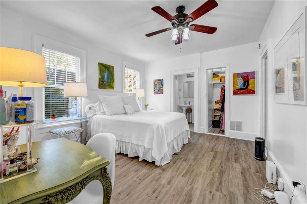 800 Myrtle Street Northeast Atlanta, GA 30308 - Photo 5 of 28 a spacious bedroom with a bed a window and a chandelier