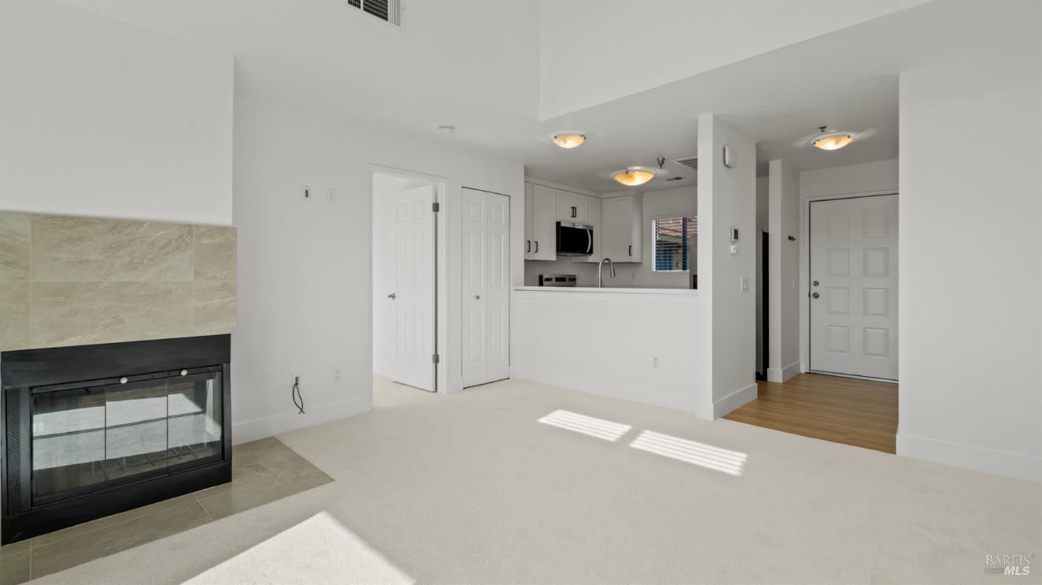 302 Mariner Way Novato, CA 94945 - Photo 11 of 20 a view of a kitchen with refrigerator and white cabinets