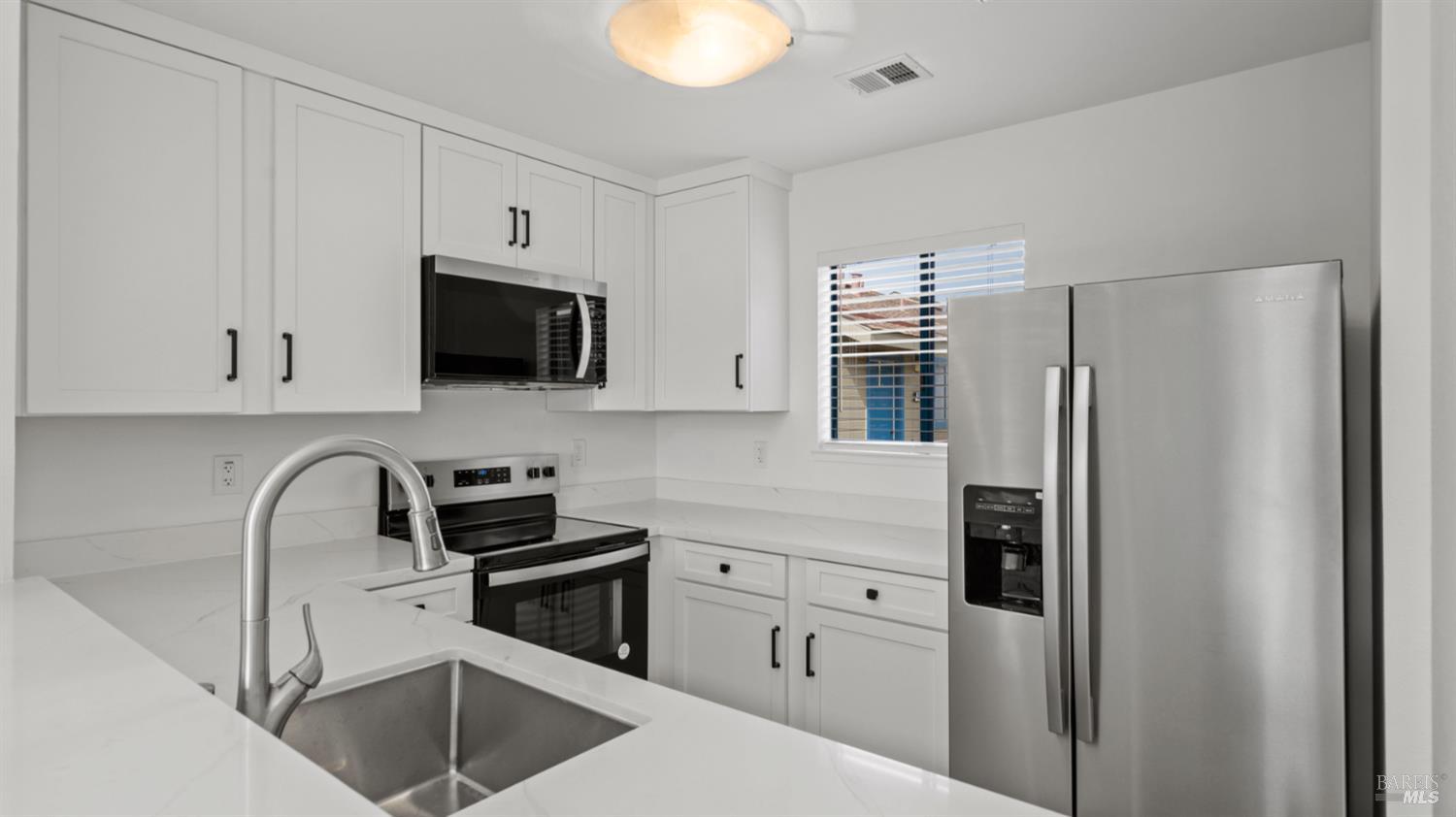 302 Mariner Way Novato, CA 94945 - Photo 9 of 20 a kitchen with cabinets stainless steel appliances and a counter space