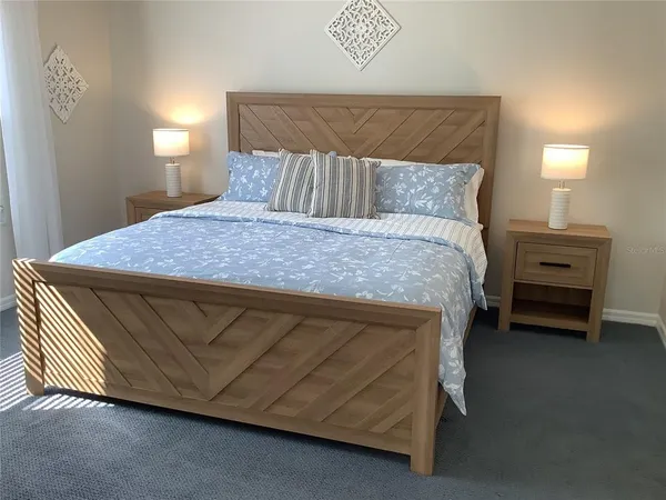 a bedroom with a bed and a lamp