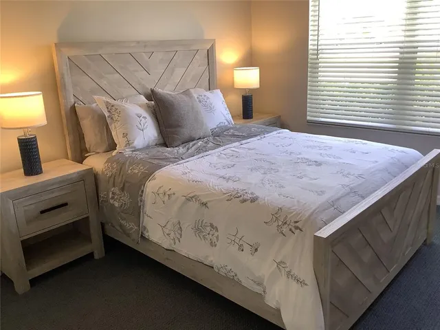 a bedroom with a bed and a lamp