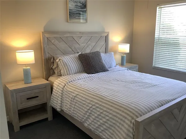 a bedroom with a bed and a lamp