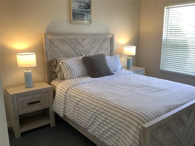 a bedroom with a bed and a lamp