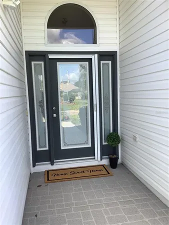 a view of an entryway door front of a house