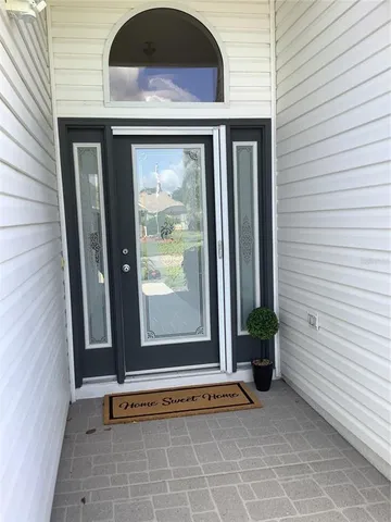 a view of an entryway door front of a house
