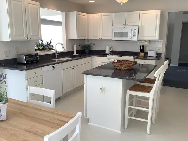 a kitchen with a stove a sink and a refrigerator