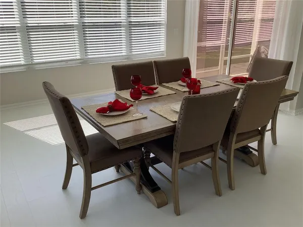 a dining room with furniture and window