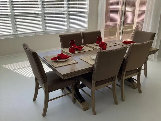 a dining room with furniture and window