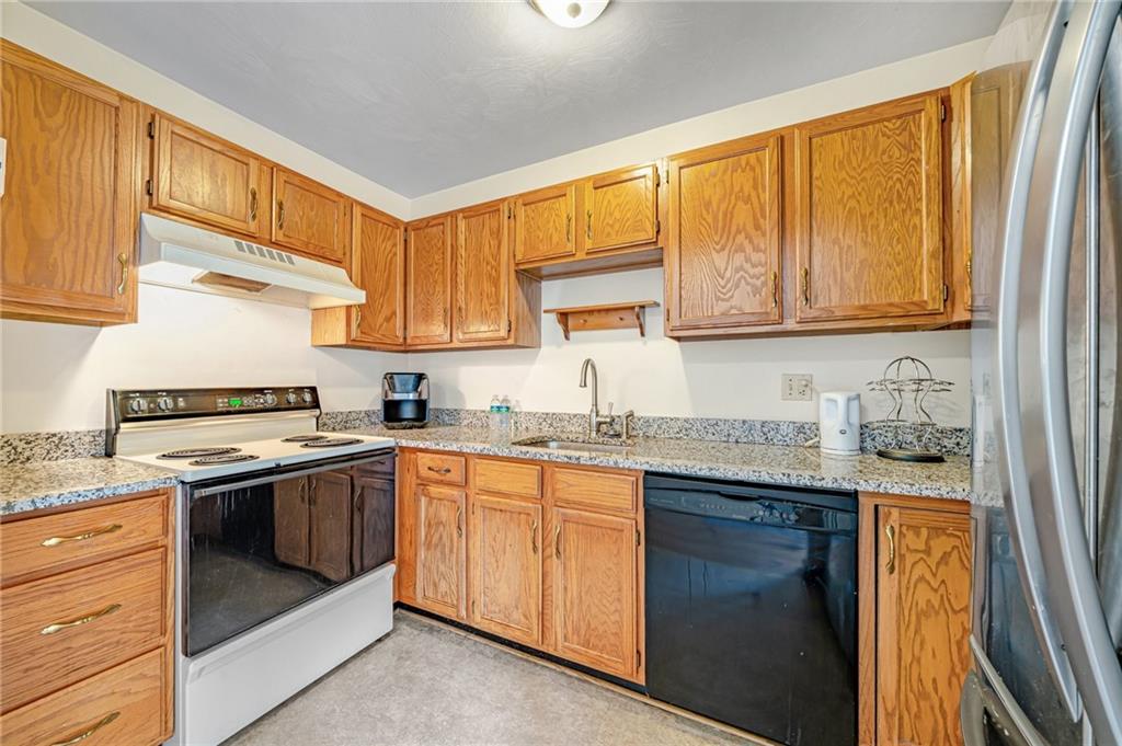 820 Mt Pleasant Road Greensburg, PA 15601 - Photo 11 of 30 a kitchen with stainless steel appliances granite countertop a stove sink and cabinets