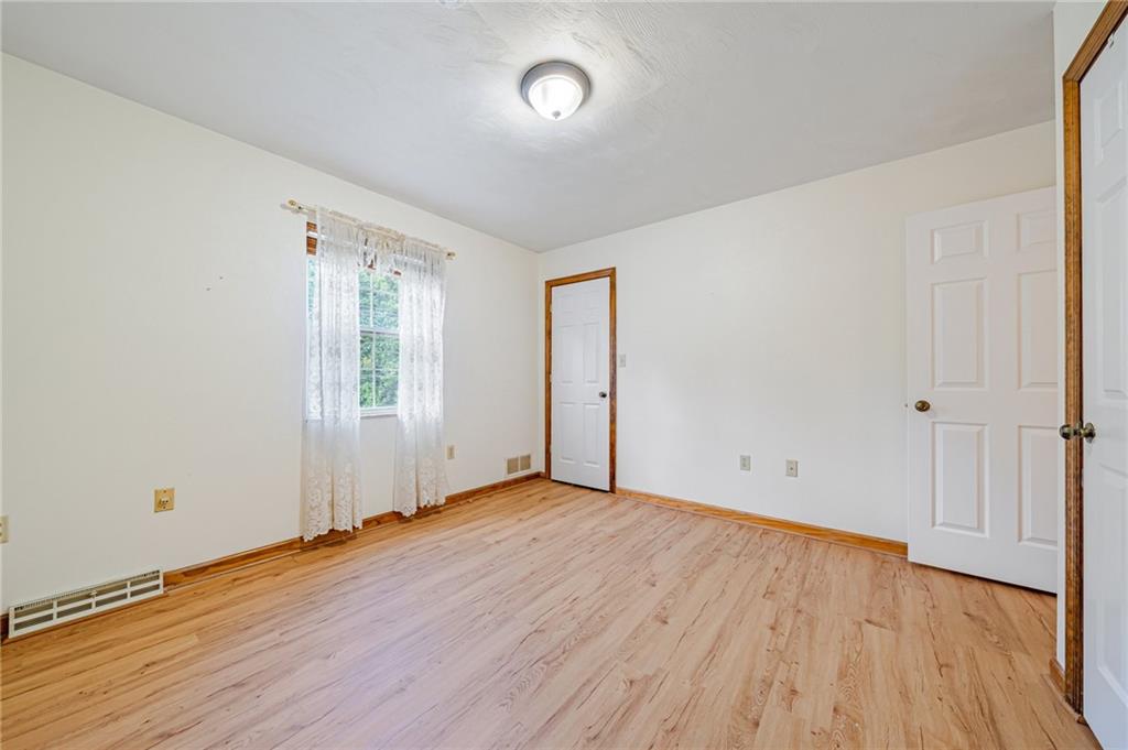 820 Mt Pleasant Road Greensburg, PA 15601 - Photo 18 of 30 an empty room with wooden floor and windows