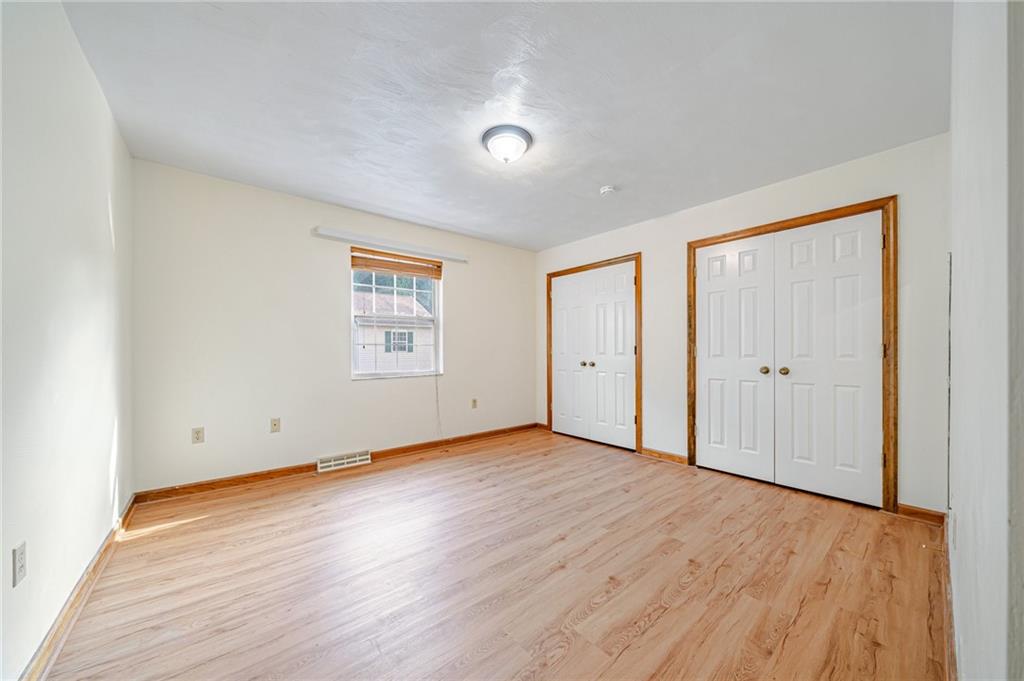 820 Mt Pleasant Road Greensburg, PA 15601 - Photo 19 of 30 an empty room with wooden floor and windows