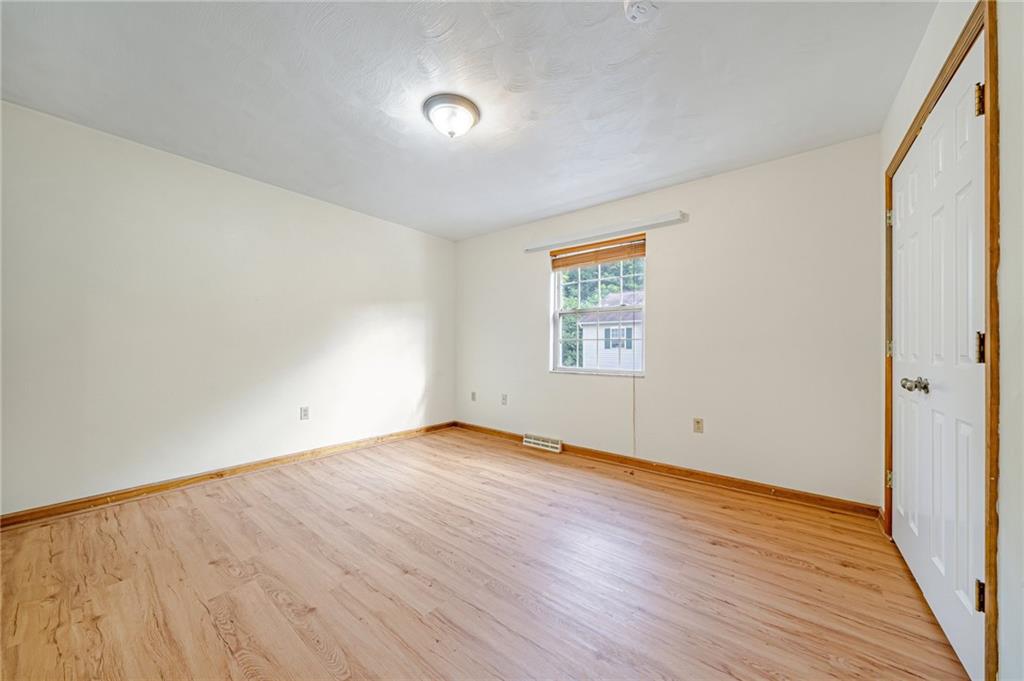 820 Mt Pleasant Road Greensburg, PA 15601 - Photo 21 of 30 an empty room with wooden floor and windows