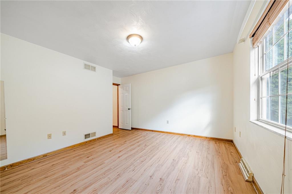 820 Mt Pleasant Road Greensburg, PA 15601 - Photo 22 of 30 an empty room with wooden floor and windows