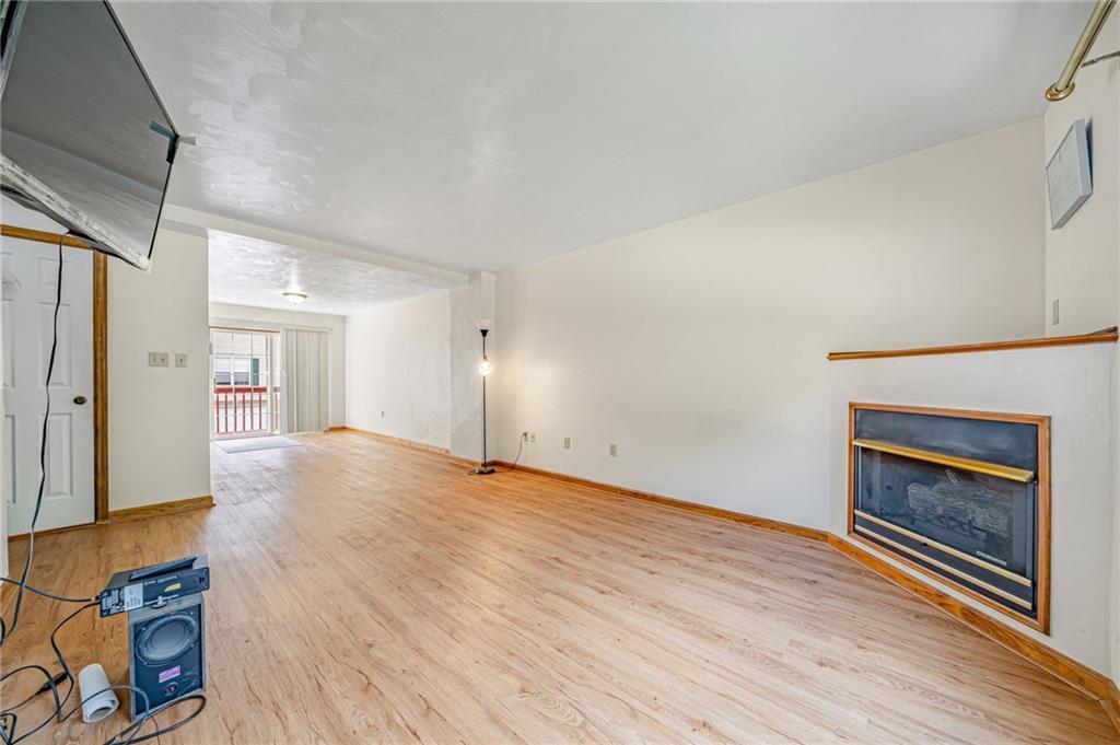 820 Mt Pleasant Road Greensburg, PA 15601 - Photo 3 of 30 a view of an empty room with wooden floor fireplace and a window