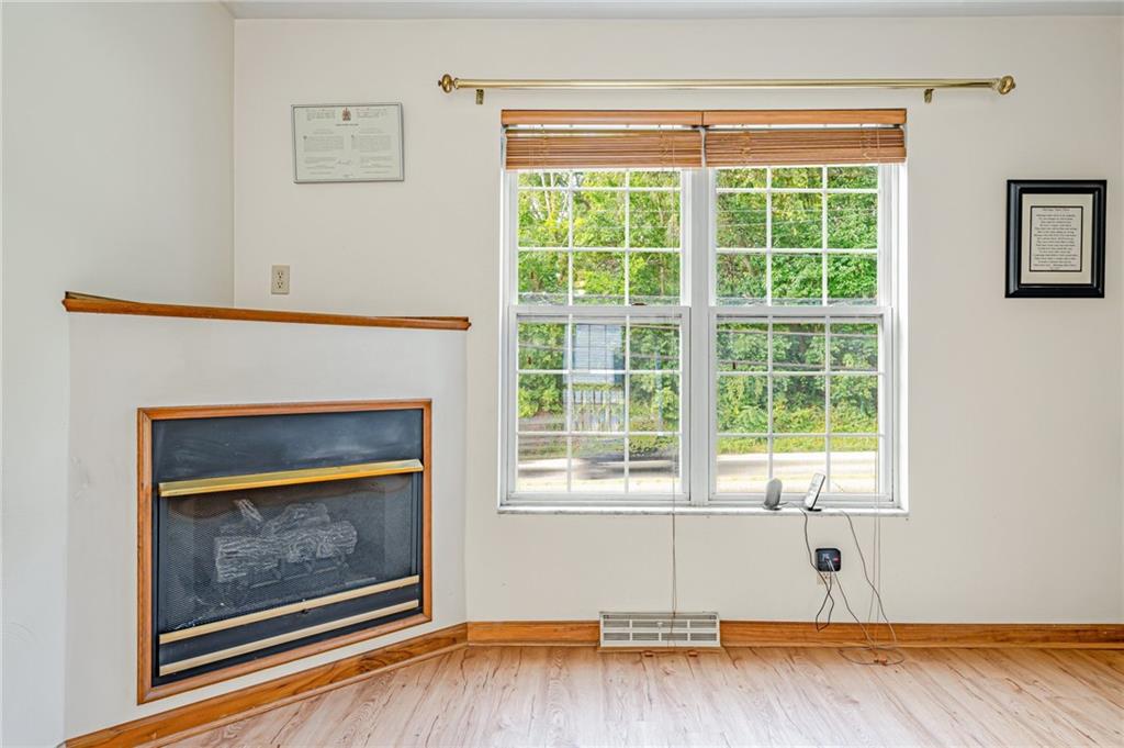 820 Mt Pleasant Road Greensburg, PA 15601 - Photo 4 of 30 a living room with a fireplace and a window