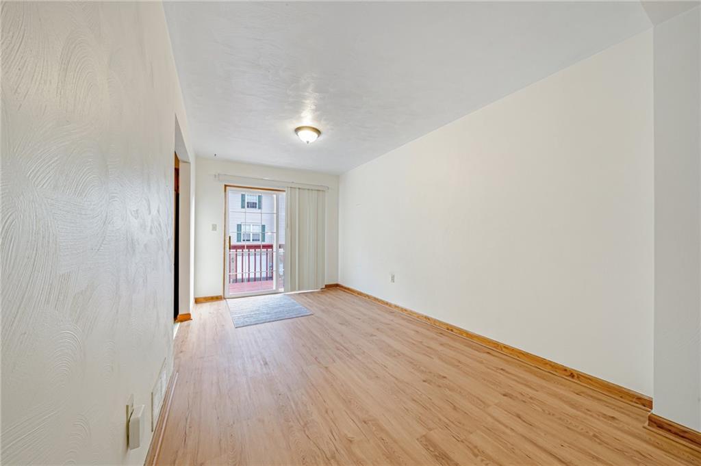 820 Mt Pleasant Road Greensburg, PA 15601 - Photo 8 of 30 a view of an empty room with a window and wooden floor